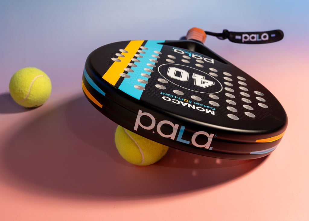 black padel racket with padel balls and details